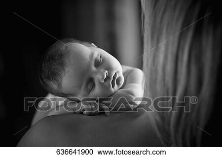 Baby boy sleeping on his mother's shoulder View Large Photo Image Stock Image - Baby boy sleeping on his mother's shoulder. Fotosearch