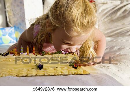 Stock Photograph - Baby girl eating birthday cake. Fotosearch