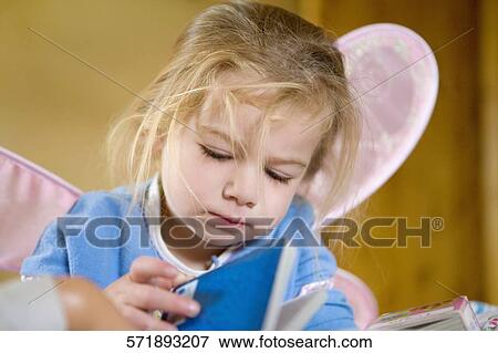 Baby girl holding a book View Large Photo Image Stock Photo - Baby girl holding a book. Fotosearch