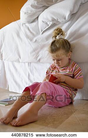 Baby girl holding a book View Large Photo Image Stock Photography - Baby girl holding a book. Fotosearch