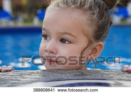 Baby girl leaning on the ledge of a swimming pool View Large Photo Image Stock Image - Baby girl leaning on the ledge of a swimming pool. Fotosearch