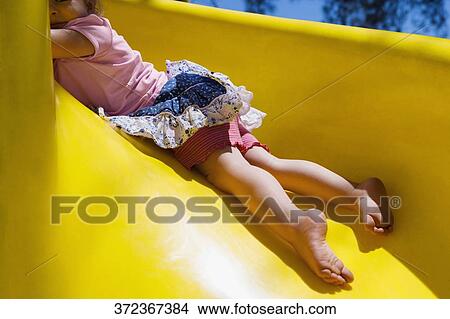 Baby girl playing on a slide, Santa Fe, New Mexico, USA View Large Photo Image Picture - Baby girl playing on a slide, Santa Fe, New Mexico, USA. Fotosearch