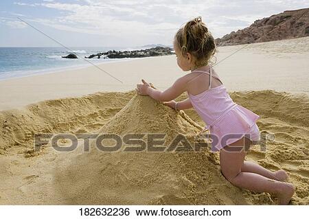 Baby girl playing with sand on the beach, Cabo San Lucas, Mexico View Large Photo Image Stock Photograph - Baby girl playing with sand on the beach, Cabo San Lucas, Mexico. Fotosearch