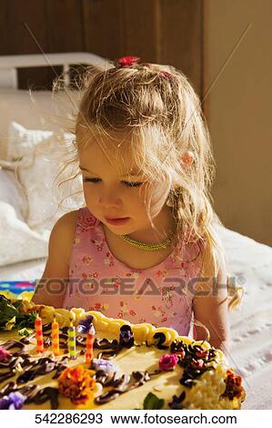 Baby girl sitting on the bed with a birthday cake View Large Photo Image Stock Image - Baby girl sitting on the bed with a birthday cake. Fotosearch