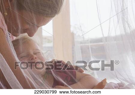 Baby girl sleeping with her mother View Large Photo Image Stock Photo - Baby girl sleeping with her mother. Fotosearch