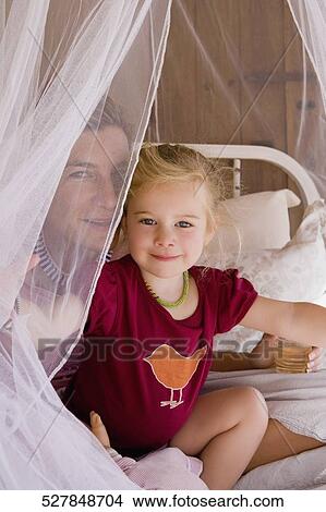Baby girl with her mother in the bedroom View Large Photo Image Picture - Baby girl with her mother in the bedroom. Fotosearch
