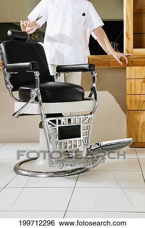 Barber in a salon View Large Photo Image Stock Photograph - Barber in a salon. Fotosearch