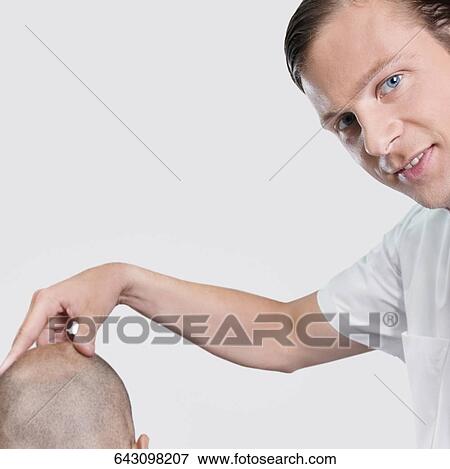 Barber massaging a man's head View Large Photo Image Stock Photo - Barber massaging a man's head. Fotosearch