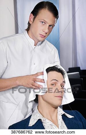 Barber rubbing a towel on a man's hair View Large Photo Image Stock Image - Barber rubbing a towel on a man's hair. Fotosearch