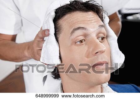 Barber rubbing a towel on a man's hair View Large Photo Image Stock Photo - Barber rubbing a towel on a man's hair. Fotosearch