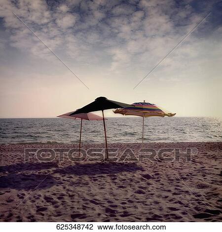 Stock Image - Beach umbrellas on the beach. Fotosearch