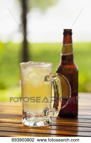 Beer glass and a bottle on a table View Large Photo Image Stock Image - Beer glass and a bottle on a table. Fotosearch