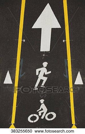 Stock Image - Bicycle lane sign on the road, Hudson River, New York City, New York State, USA. Fotosearch