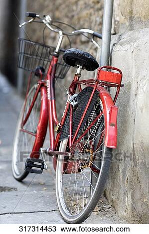 Bicycle leaning against a wall View Large Photo Image Stock Image - Bicycle leaning against a wall. Fotosearch