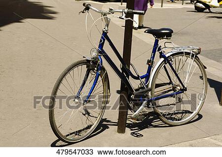 Bicycle locked to a pole View Large Photo Image Stock Image - Bicycle locked to a pole. Fotosearch