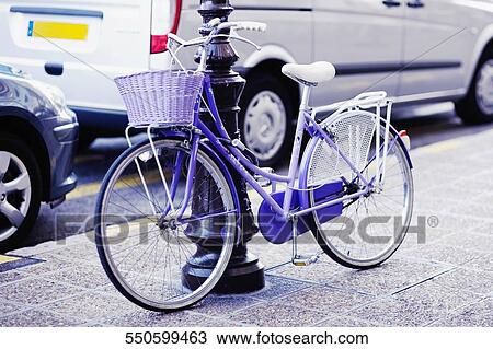 Bicycle parked against a post at the roadside, Barcelona, Spain View Large Photo Image Stock Image - Bicycle parked against a post at the roadside, Barcelona, Spain. Fotosearch