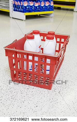 Bottles in a shopping basket in a supermarket View Large Photo Image Stock Image - Bottles in a shopping basket in a supermarket. Fotosearch