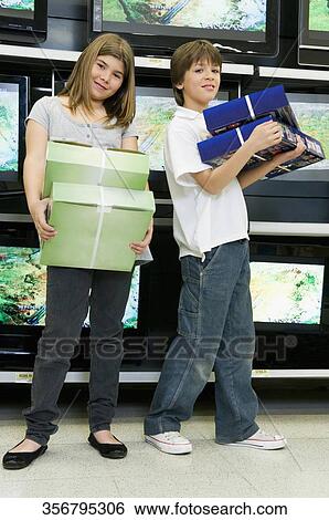 Stock Photograph - Boy and a girl shopping in a supermarket. Fotosearch
