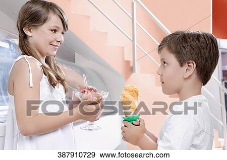 Boy and his sister holding ice creams View Large Photo Image Stock Photo - Boy and his sister holding ice creams. Fotosearch
