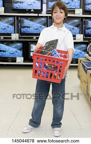 Boy carrying a shopping basket in a supermarket View Large Photo Image Stock Photo - Boy carrying a shopping basket in a supermarket. Fotosearch