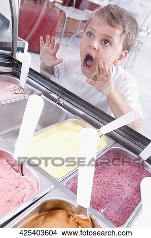 Picture - Boy choosing ice cream in an ice cream parlor. Fotosearch