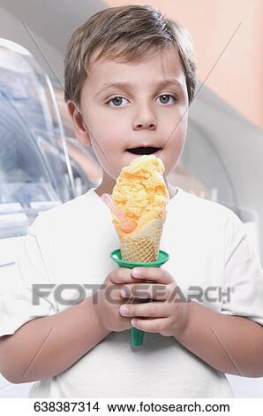 Picture - Boy eating an ice cream. Fotosearch