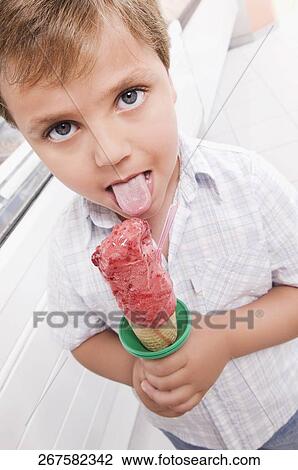 Stock Image - Boy licking an ice cream. Fotosearch