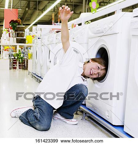 Boy playing in a supermarket View Large Photo Image Stock Photo - Boy playing in a supermarket. Fotosearch