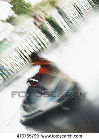 Boy riding a bumper car View Large Photo Image Stock Photo - Boy riding a bumper car. Fotosearch