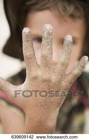Boy showing his muddy hand View Large Photo Image Stock Image - Boy showing his muddy hand. Fotosearch