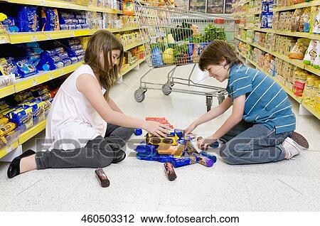 Boy with his sister shopping in a supermarket View Large Photo Image Stock Image - Boy with his sister shopping in a supermarket. Fotosearch