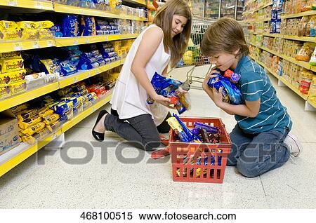 Stock Photography - Boy with his sister shopping in a supermarket. Fotosearch