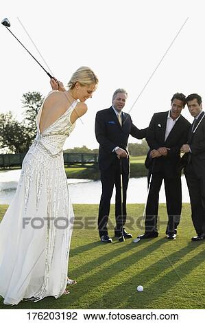 Bride playing golf and three men watching her, Biltmore Golf Course, Coral Gables, Florida, USA View Large Photo Image Stock Image - Bride playing golf and three men watching her, Biltmore Golf Course, Coral Gables, Florida, USA. Fotosearch