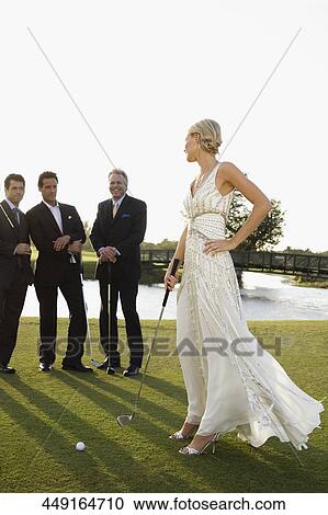 Bride playing golf and three men watching her, Biltmore Golf Course, Coral Gables, Florida, USA View Large Photo Image Stock Image - Bride playing golf and three men watching her, Biltmore Golf Course, Coral Gables, Florida, USA. Fotosearch