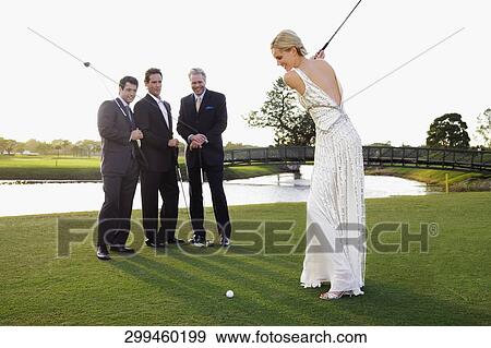 Bride playing golf and three men watching her, Biltmore Golf Course, Coral Gables, Florida, USA View Large Photo Image Stock Photo - Bride playing golf and three men watching her, Biltmore Golf Course, Coral Gables, Florida, USA. Fotosearch