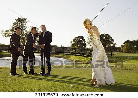 Bride playing golf and three men watching her, Biltmore Golf Course, Coral Gables, Florida, USA View Large Photo Image Stock Photo - Bride playing golf and three men watching her, Biltmore Golf Course, Coral Gables, Florida, USA. Fotosearch