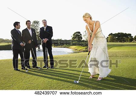 Bride playing golf and three men watching her, Biltmore Golf Course, Coral Gables, Florida, USA View Large Photo Image Stock Photo - Bride playing golf and three men watching her, Biltmore Golf Course, Coral Gables, Florida, USA. Fotosearch