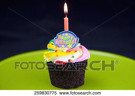 Burning candle on a birthday cake View Large Photo Image Stock Photography - Burning candle on a birthday cake. Fotosearch