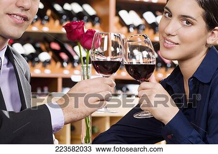 Business couple toasting with wine View Large Photo Image Stock Image - Business couple toasting with wine. Fotosearch