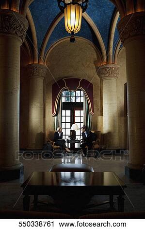 Stock Image - Business executives in a business meeting, Biltmore Hotel, Coral Gables, Florida, USA. Fotosearch