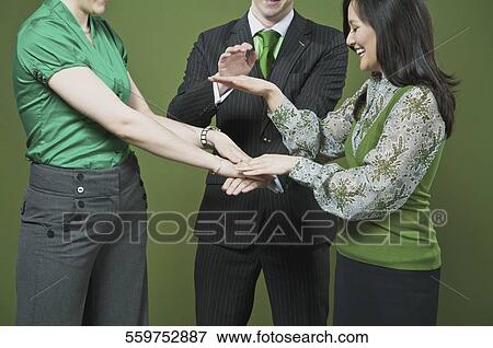 Business executives stacking hands on each other View Large Photo Image Stock Photo - Business executives stacking hands on each other. Fotosearch