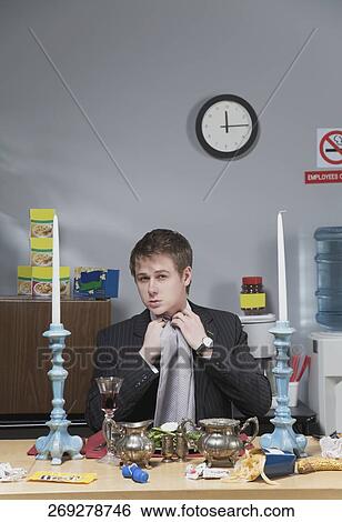 Stock Photograph - Businessman adjusting napkin in lunch break. Fotosearch