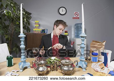 Businessman checking the time in lunch break View Large Photo Image Stock Image - Businessman checking the time in lunch break. Fotosearch