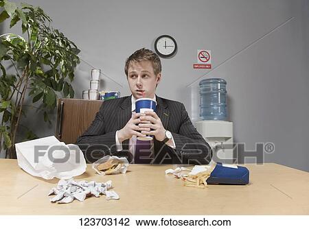 Businessman drinking beverage in lunch break View Large Photo Image Stock Image - Businessman drinking beverage in lunch break. Fotosearch