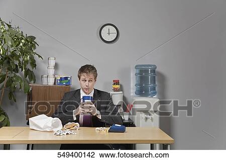 Businessman drinking beverage in lunch break View Large Photo Image Stock Image - Businessman drinking beverage in lunch break. Fotosearch
