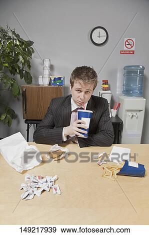 Businessman drinking beverage in lunch break View Large Photo Image Stock Photo - Businessman drinking beverage in lunch break. Fotosearch