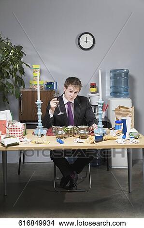 Businessman having lunch in the office View Large Photo Image Picture - Businessman having lunch in the office. Fotosearch