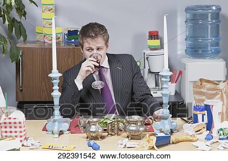 Businessman having lunch in the office View Large Photo Image Stock Image - Businessman having lunch in the office. Fotosearch