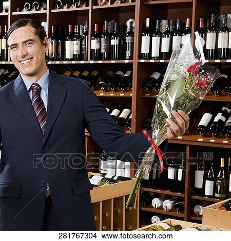 Businessman holding a bouquet of flowers View Large Photo Image Picture - Businessman holding a bouquet of flowers. Fotosearch