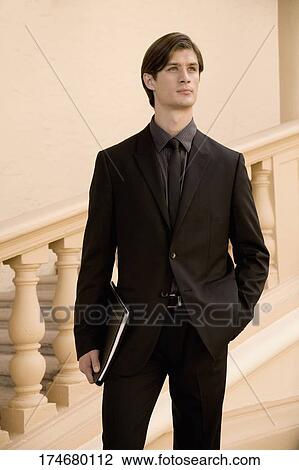 Businessman holding a file in a hotel, Biltmore Hotel, Coral Gables, Florida, USA View Large Photo Image Stock Image - Businessman holding a file in a hotel, Biltmore Hotel, Coral Gables, Florida, USA. Fotosearch